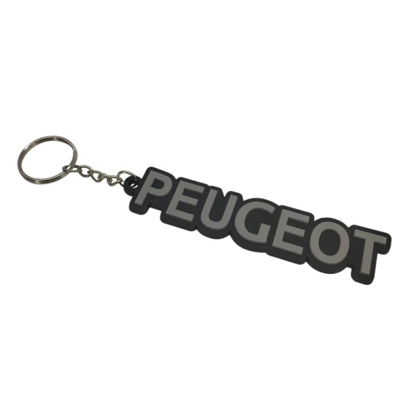 Un accessoire incontournable : porte-clé PEUGEOT, inspiré du design des coffres arrière d’époque.